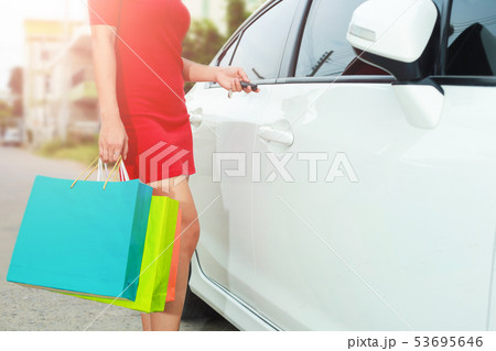 Beautiful girl is holding shopping bags and press 53695646