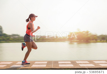 Young fitness woman running in the park. Young fitness woman running in the park. 53695671