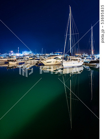Ships in the harbor under the night starry sky. Ships in the harbor under the night starry sky. 53695835