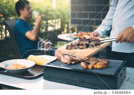 Asian men are pinching pork on a wooden cutting 53696464