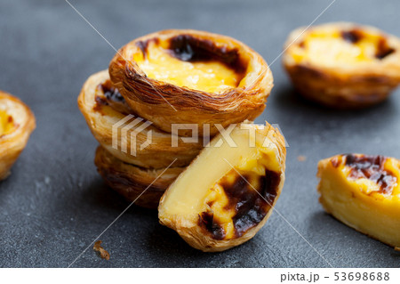 Egg tart, traditional Portuguese dessert, pastel de nata. Slate background. Close up. Egg tart, traditional Portuguese dessert, pastel de nata. Slate background. Close up. 53698688