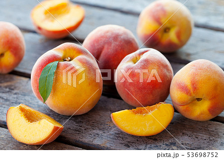 Fresh peaches, fruits on grey wooden background. Close up. 53698752