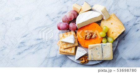 Assortment of cheese, grapes and crackers. Marble background. Top view. Copy space. 53698780