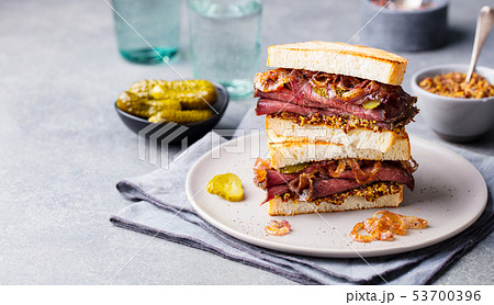 Roast beef sandwich on a plate with pickles. Copy space. Roast beef sandwich on a plate with pickles. Copy space. 53700396