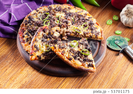 Spicy pizza with minced meat and jalopeno 53701175