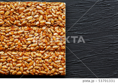 Tile kozinaki from sunflower seeds on a black 53701331
