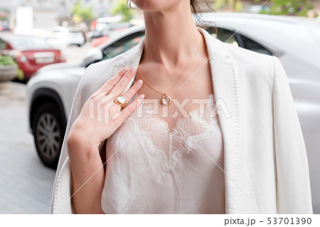 People, fashion, jewelry and luxury concept, closeup of woman wearing luxury jewelry standing near 53701390