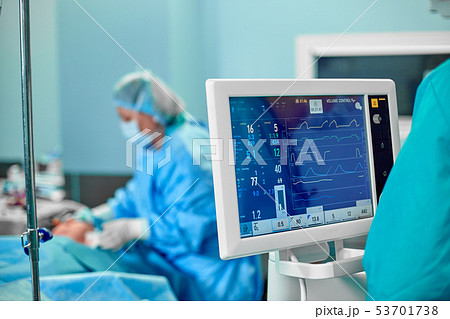 Electrocardiogram in hospital surgery operating emergency room showing patient heart rate with blur Electrocardiogram in hospital surgery operating emergency room showing patient heart rate with blur 53701738