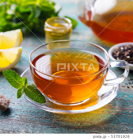 Tea cup with mint leaf and lemon. Wooden background. Close up. 53701926