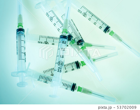 Syringes on blue background 53702009