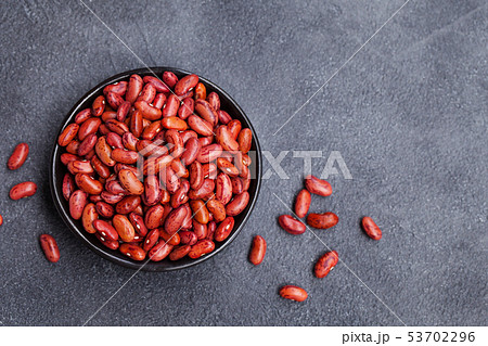 Red lentil in a black bowl on grey stone background. Top view. Copy space. Red lentil in a black bowl on grey stone background. Top view. Copy space. 53702296