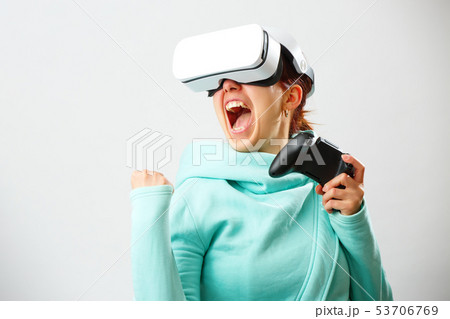 Woman with virtual reality headset is playing game. Woman with virtual reality headset is playing game. 53706769