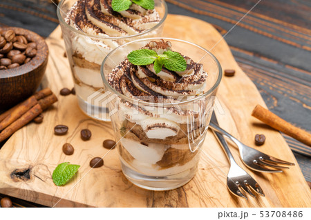 Classic tiramisu dessert in a glass on wooden background Classic tiramisu dessert in a glass on wooden background 53708486