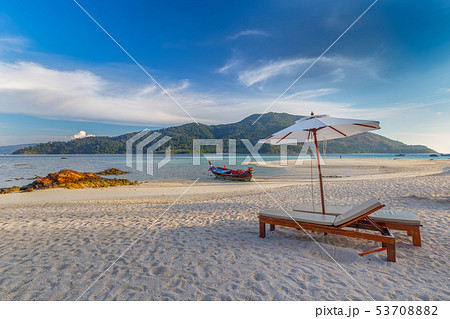 Beach chairs,umbrella and palms on beautiful beach Beach chairs,umbrella and palms on beautiful beach 53708882