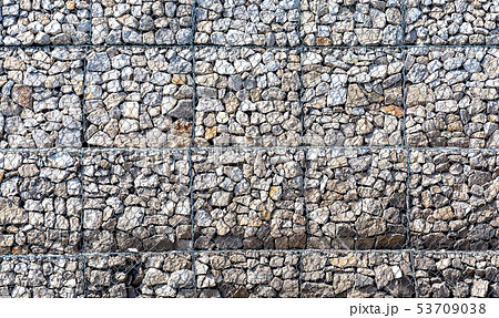 Stone wall with metal grid as background Stone wall with metal grid as background 53709038