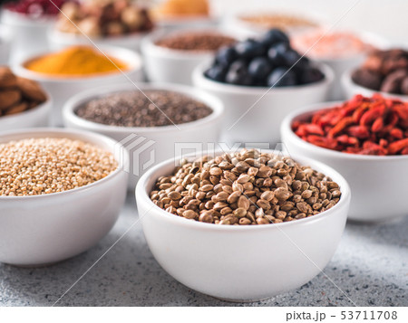 Hemp seeds in small white bowl and other superfood 53711708