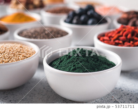 Spirulina in small white bowl and other superfoods Spirulina in small white bowl and other superfoods 53711711