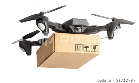 Drone with a cardboard box makes delivery by air. Drone with a camera carries postal parcel. Drone with a cardboard box makes delivery by air. Drone with a camera carries postal parcel. 53712737