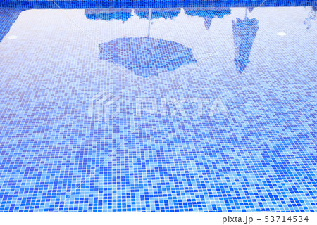 Swimming pool seaside view scene with umbrella shadow on the water Swimming pool seaside view scene with umbrella shadow on the water 53714534
