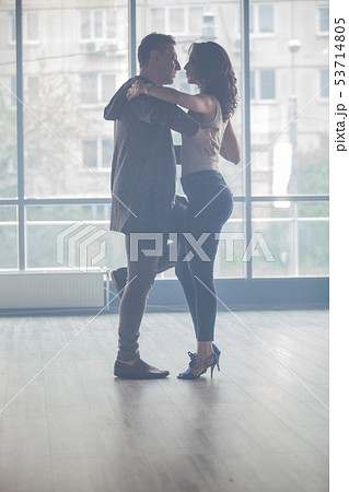 Beautiful couple dancing kizomba in dance studio Beautiful couple dancing kizomba in dance studio 53714805