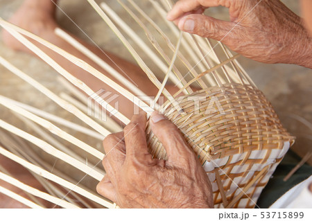 Senior man hands manually weaving bamboo. 53715899