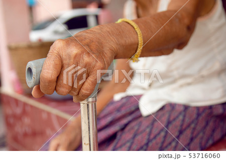 hands of old woman asia with a cane walking stick hands of old woman asia with a cane walking stick 53716060