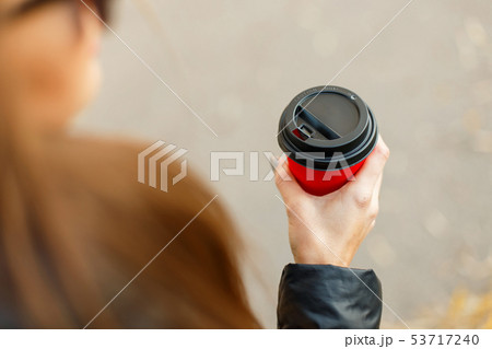 young girl holds a delicious coffee in a red cup young girl holds a delicious coffee in a red cup 53717240