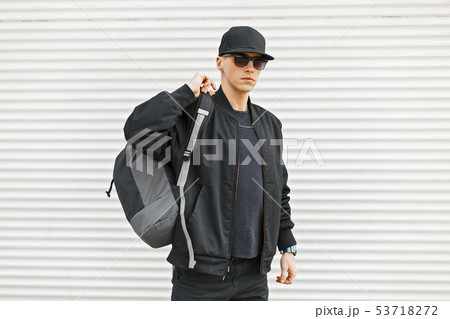 Stylish young man in black modern clothes Stylish young man in black modern clothes 53718272