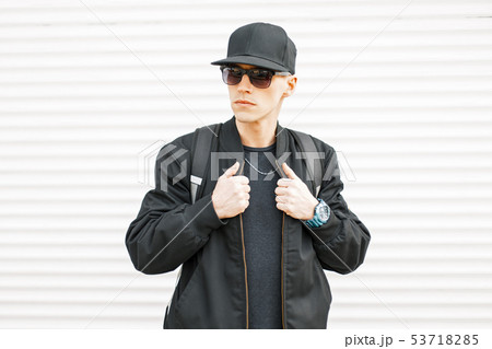 Handsome man with black glasses, a cap, a jacket Handsome man with black glasses, a cap, a jacket 53718285