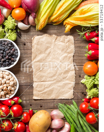 Vegetables, paper and chickpea on a wooden table 53719412