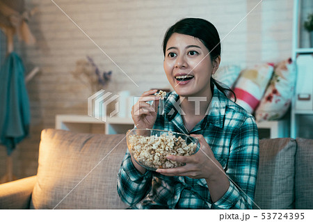 woman home alone watching television smiling 53724395