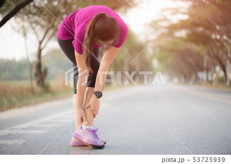 Woman suffering from an ankle injury 53725939