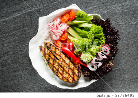 grilled salmon steak with fresh vegetables 53726495