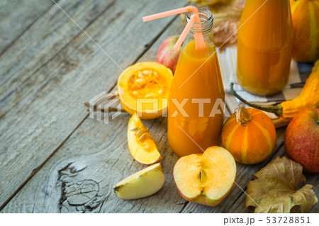 Apple and pumpkin smoothie in glass bottles Apple and pumpkin smoothie in glass bottles 53728851