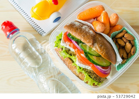 Vegan sandwich in lunch box with carrots and nuts 53729042