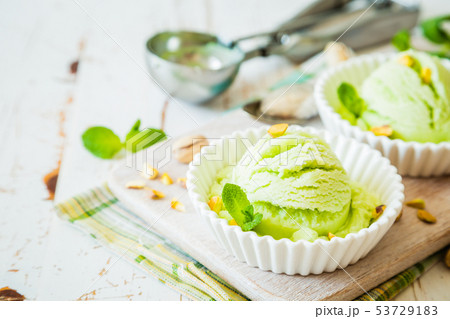 Pistachio ice cream in white bowl Pistachio ice cream in white bowl 53729183