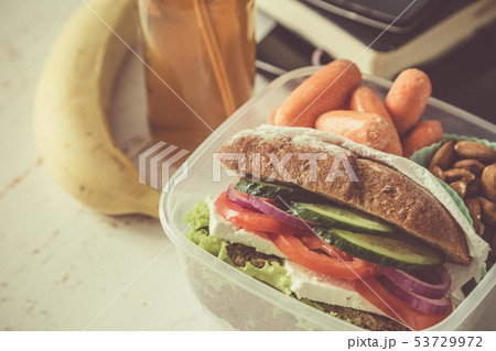 Vegan sandwich in lunch box with carrots and nuts 53729972