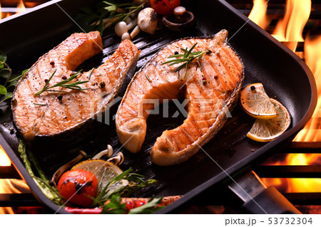 Grilled salmon fish on the flaming grill Grilled salmon fish on the flaming grill 53732304