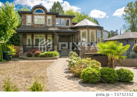 Modern luxury residential house with paved driveway on cloudy sky background 53732332