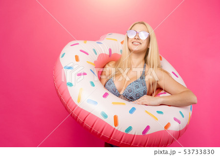 Image of smiling girl in swimsuit sunglasses with inflatable donut for swimming Image of smiling girl in swimsuit sunglasses with inflatable donut for swimming 53733830