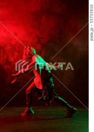 Photo of side of young dancing girl on green-green background 53733910
