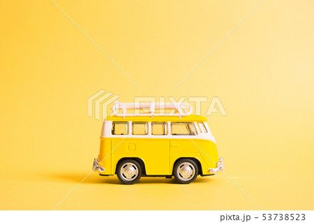 Funny yellow retro car with surfboard  53738523