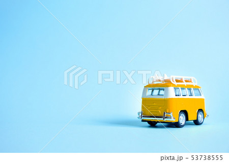 Funny yellow retro car with surfboard  53738555