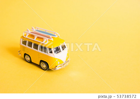 Funny yellow retro car with surfboard  53738572