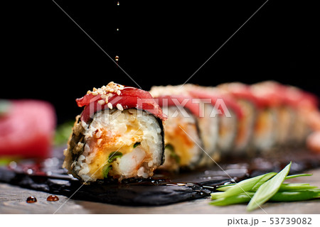 Serving sushi rolls and other traditional japanese and asian food on a table 53739082