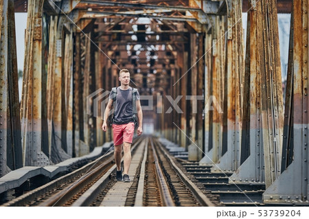 Traveler walking on railway bridge 53739204