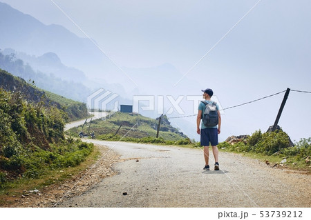 Man on winding road 53739212