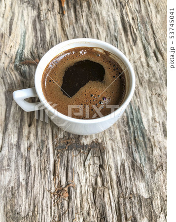 a cup of coffee on a wooden table a cup of coffee on a wooden table 53745041