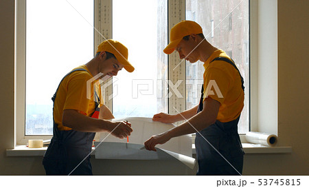 Construction workers looking at blueprint. Construction workers looking at blueprint. 53745815