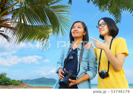 Two tourist women hold camera feel relax with sea 53746179